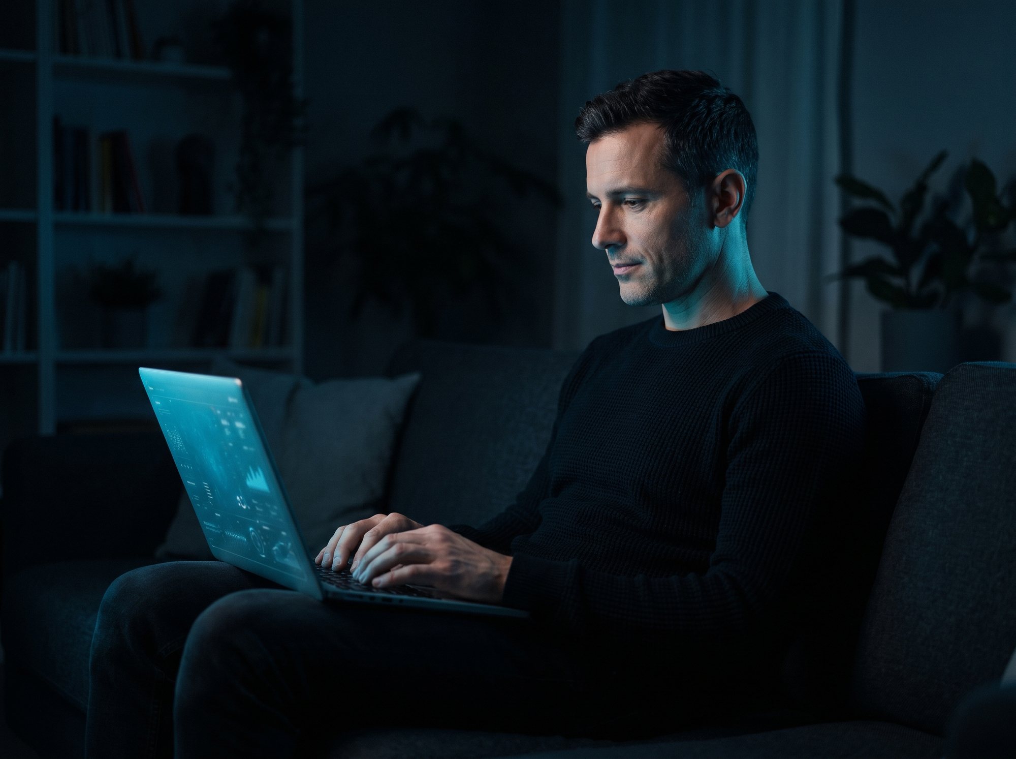 A man reading his blood test results on a laptop at home in the evening